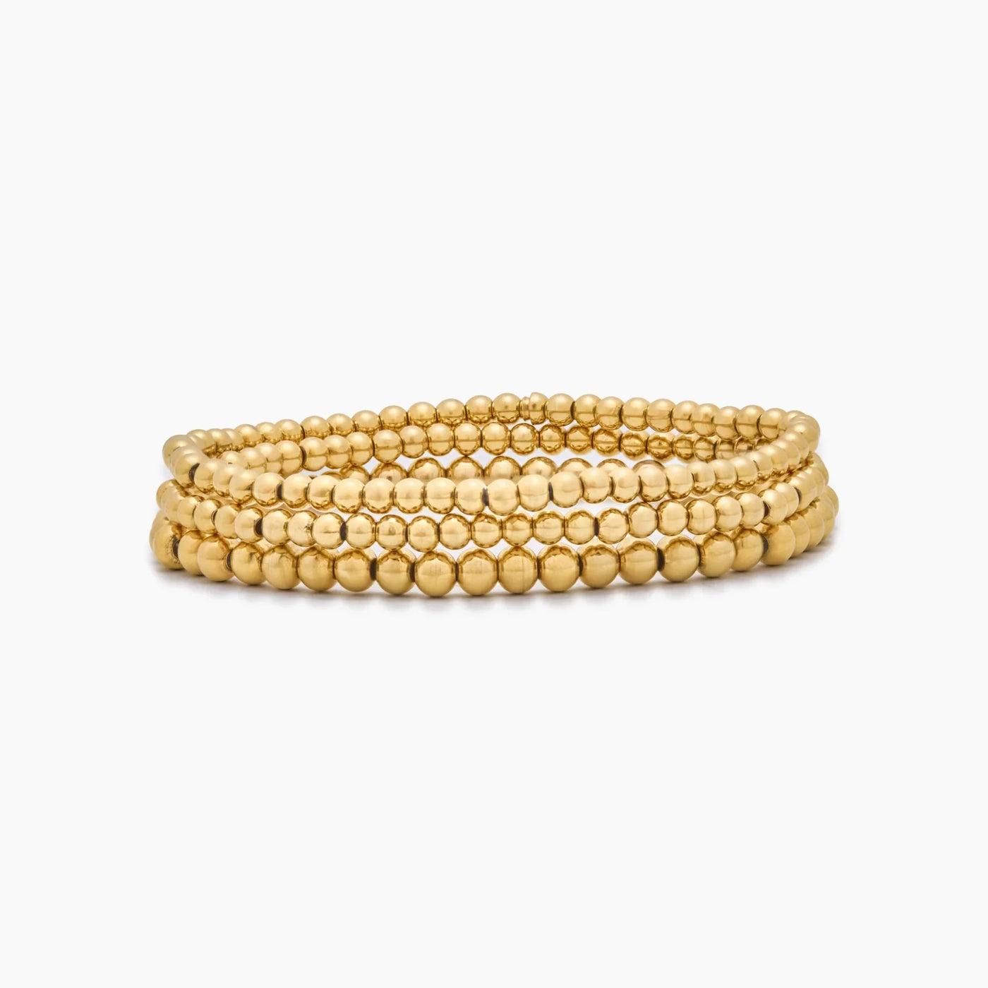 Pulsera Triple Esferas Oriana dorada sobre fondo blanco