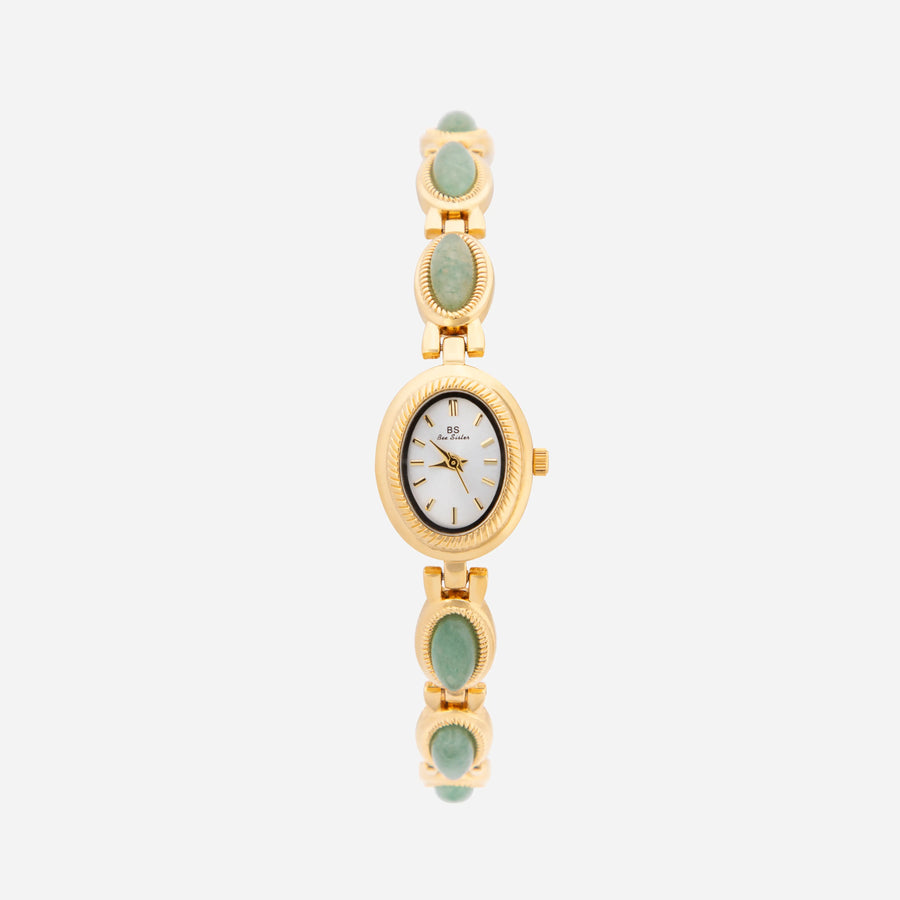 Reloj Rectangular Nerina dorado con detalles verde esmeralda sobre fondo claro
