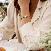 Mujer llevando el Reloj Rectangular Nerina dorado en la muñeca